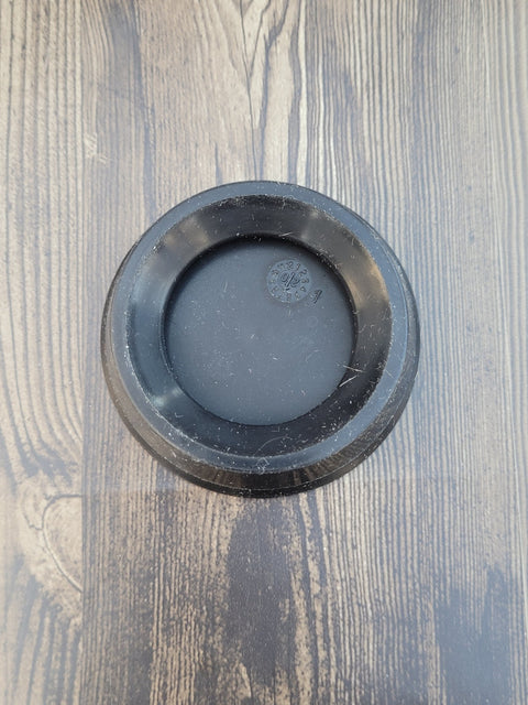 AeroPress plunger seal, black rubber, inside view.