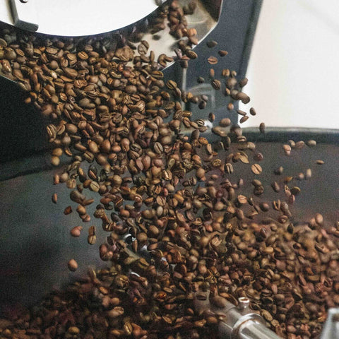 Coffee beans coming out of the roaster into cooling tray.
