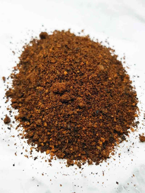 Sipping Duck coffee spice rub on white surface.