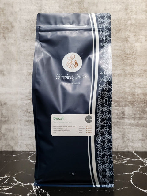 Sipping Duck Decaf Swiss water process 1kg blue coffee bag with unique pattern and label with profile description.