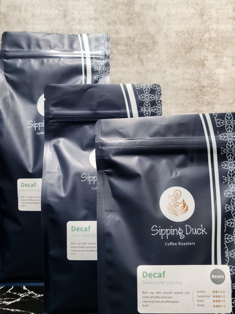 Sipping Duck Decaf Swiss water process blue coffee bag with unique pattern and label with profile description. 3 size bags.