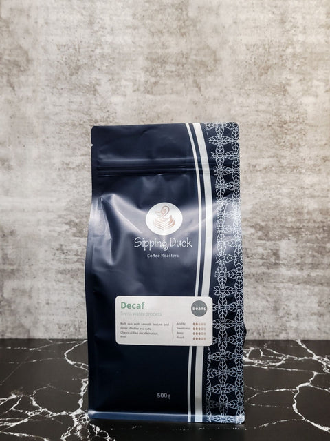 Sipping Duck Decaf Swiss water process 125g blue coffee bag with unique pattern and label with profile description.