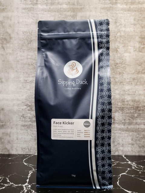Sipping Duck Specialty Coffee Roasters Face Kicker Blend, dark roast in 1kg blue bag with profile description and unique pattern.