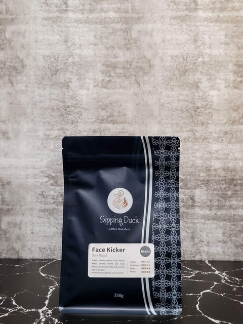 Sipping Duck Specialty Coffee Roasters Face Kicker Blend, dark roast in 250g blue bag with profile description and unique pattern.