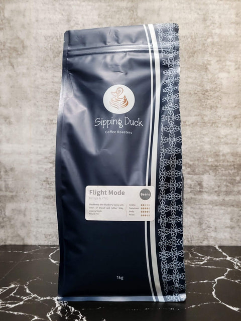 Sipping Duck Coffee Roasters Flight Mode blend in 1kg blue bag with unique pattern and label with profile description.