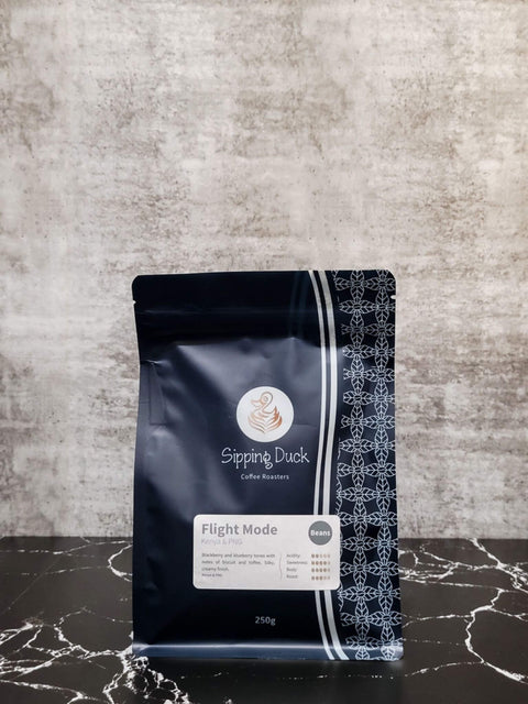 Sipping Duck Coffee Roasters Flight Mode blend in 250g blue bag with unique pattern and label with profile description.
