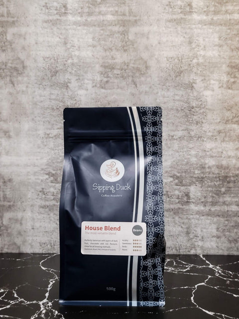 Sipping Duck Specialty Coffee Roasters House Blend 500g bag, blue with unique pattern.