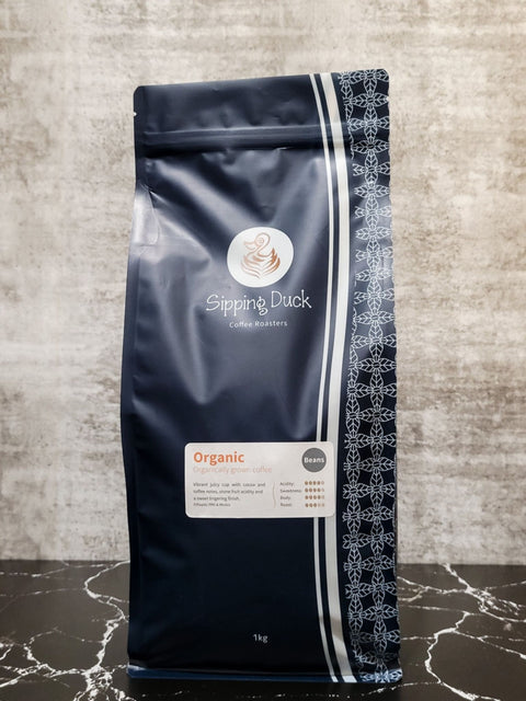 Sipping Duck Coffee Roasters Organic blend in blue 1kg bag with unique pattern and label with blend description.