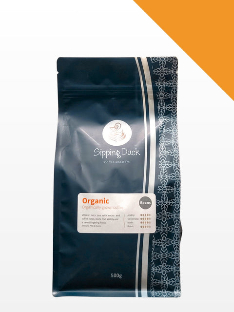 Sipping Duck Organic blend specialty coffee bag, medium roast espresso blend, 500g size, product picture with profile details, orange line, white background.