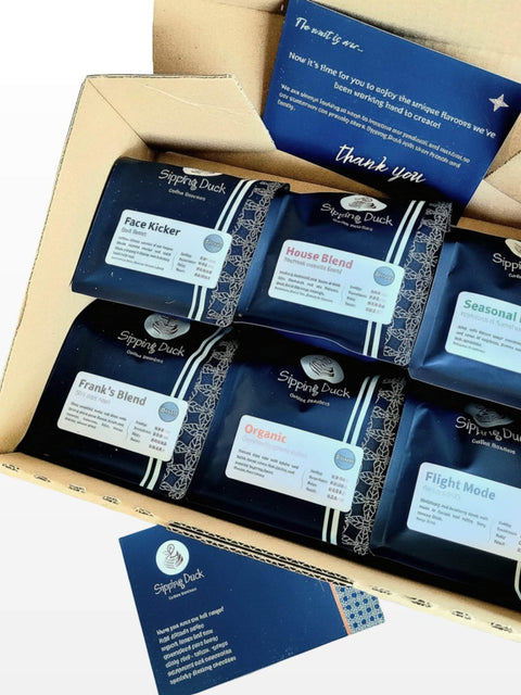 Box of Sipping Duck coffee packages inside a box with thank you card.